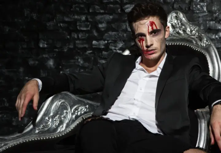 Mężczyzna w garniturze, z krwią na twarzy, siedzi na ozdobnym tronie. Czy Patrick Bateman naprawdę zabijał?