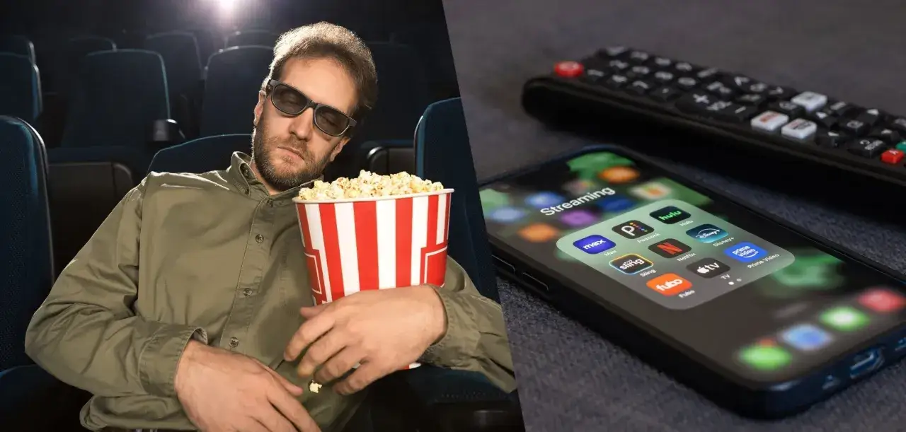 Zmęczony widz w kinie z popcornem obok smartfona z aplikacjami streamingowymi. Zastanawiasz się, jak długo filmy są w kinach, zanim trafią na platformy?