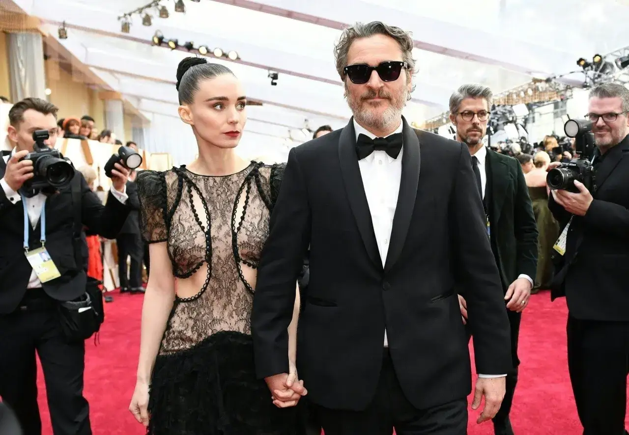 Joaquin Phoenix, który grał Jokera w filmie Joker, idzie z Rooney Marą po czerwonym dywanie.