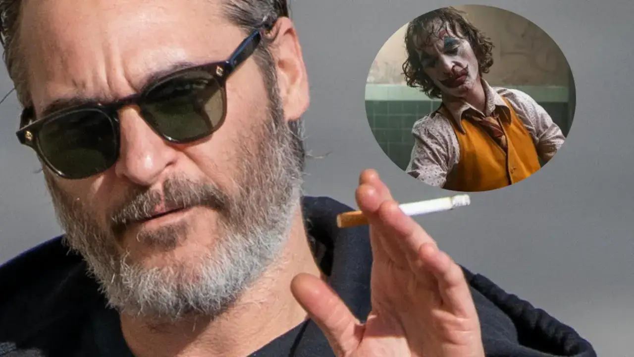 Joaquin Phoenix, który grał Jokera w filmie Joker, pali papierosa.